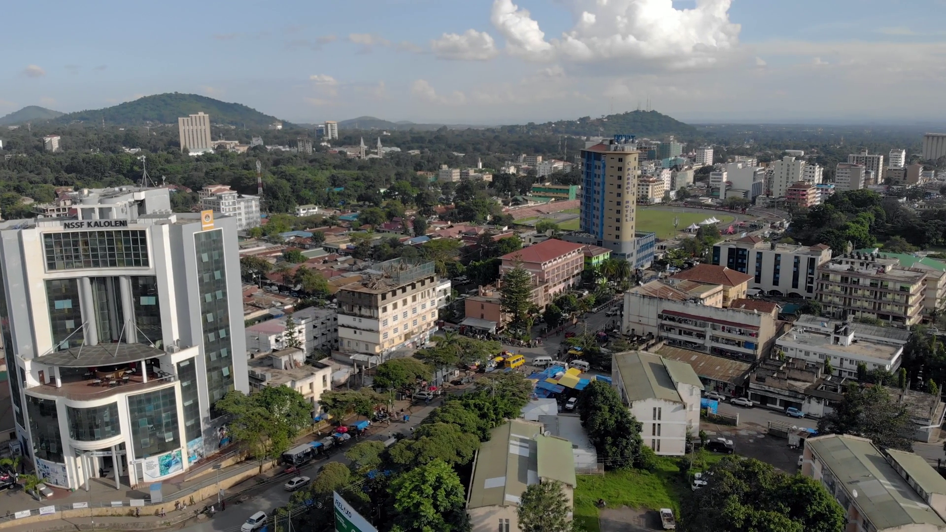 videoblocks-aerial-close-flyby-view-of-the-city-of-arusha-tanzania-mountains-and-volcano-on-background_hfrhol4gp_thumbnail-1080_01
